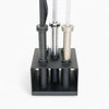 Set of metal barbells in a black holder on a white background