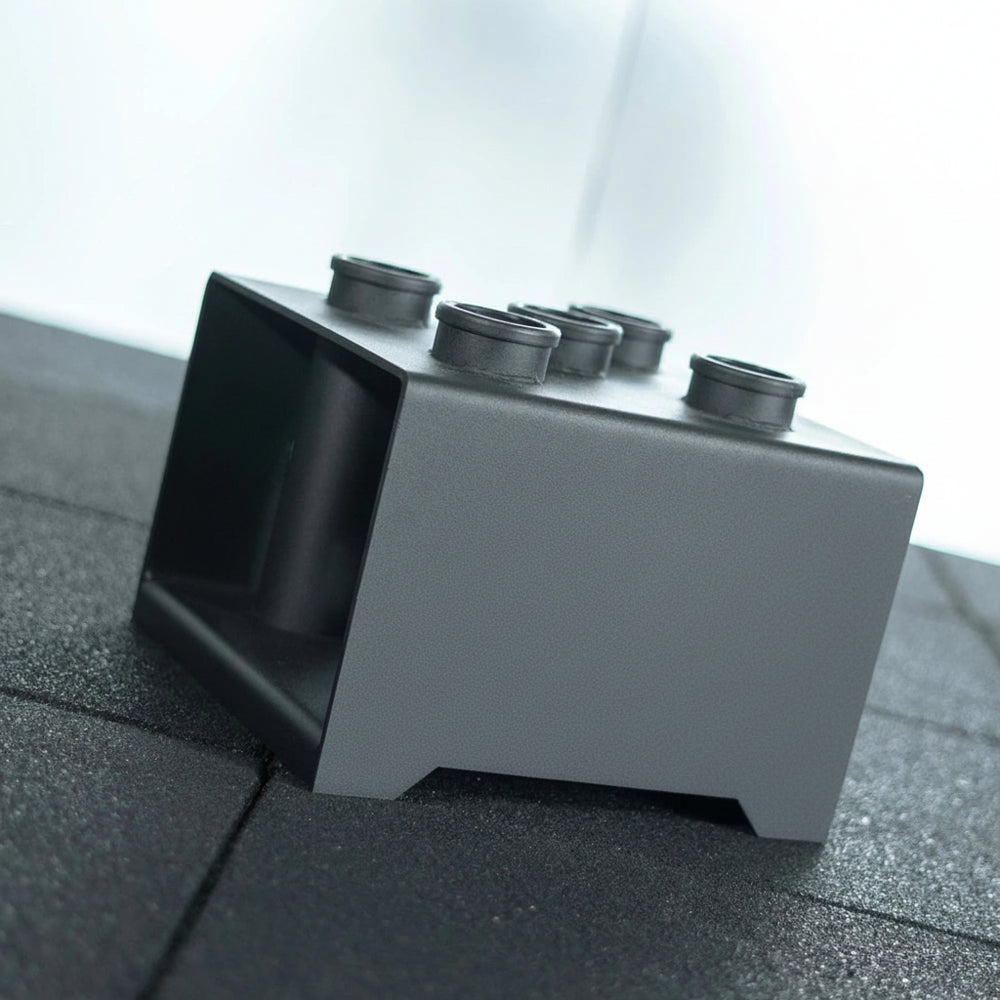 Black weight bar holder on a gym floor.