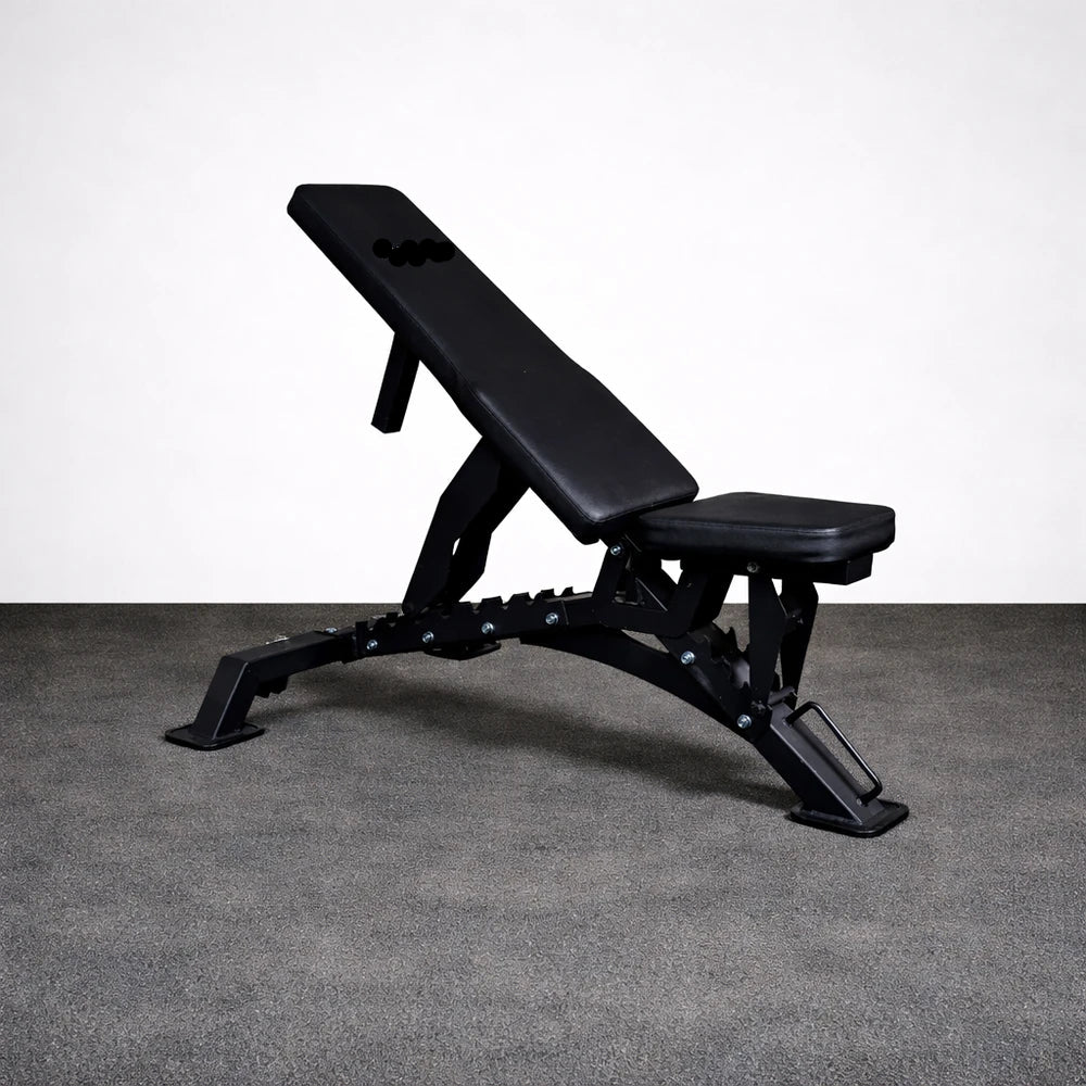 Black adjustable weight bench on a gray floor with a white background