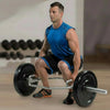Man performing a barbell squat in a gym setting