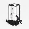 Gym power rack with weight plates and bench on a white background