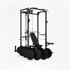 Gym power rack with weight plates on a white background