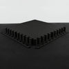 Black interlocking foam mats on a black surface with a light gray background