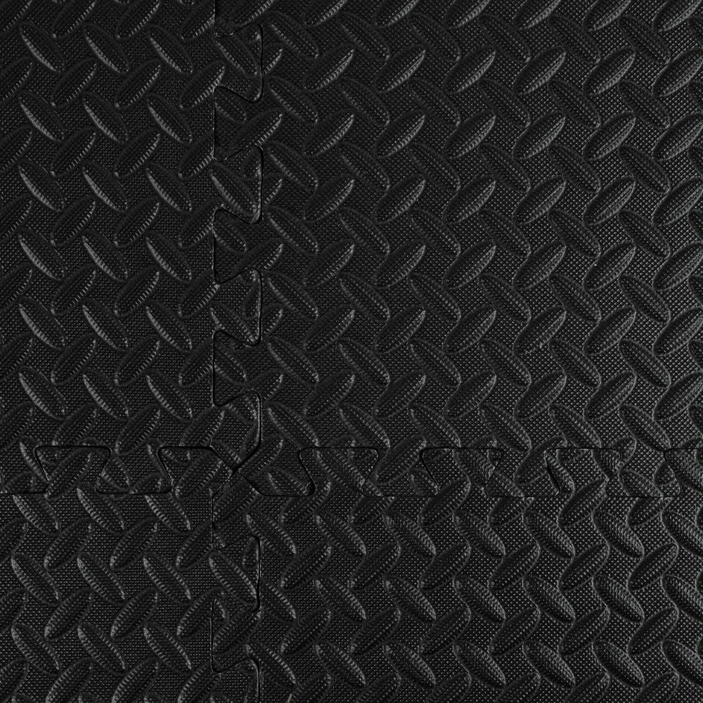 Close-up of a black textured pattern on foam gym mats