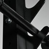 Close-up of a metal barbell with textured surface on a gray background