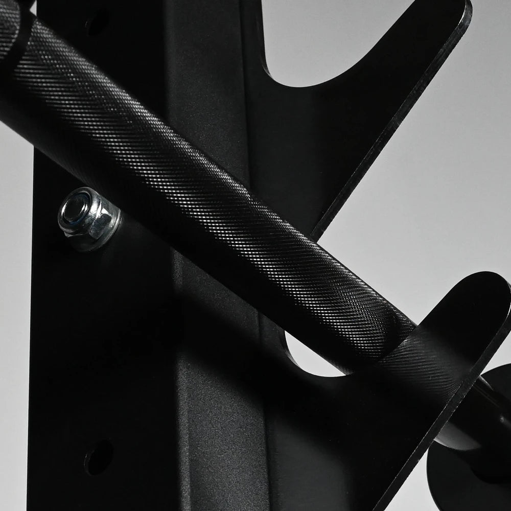 Close-up of a metal barbell with textured surface on a gray background