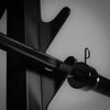 Close-up of a metal barbell with a clip on a gray background