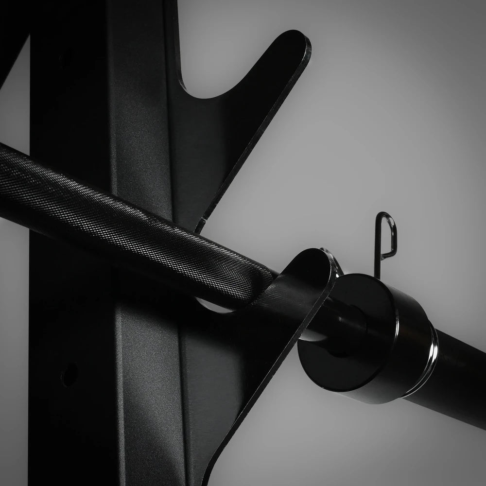 Close-up of a metal barbell with a clip on a gray background