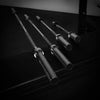 Set of barbells on a black surface