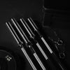 Set of metal barbell on a dark surface