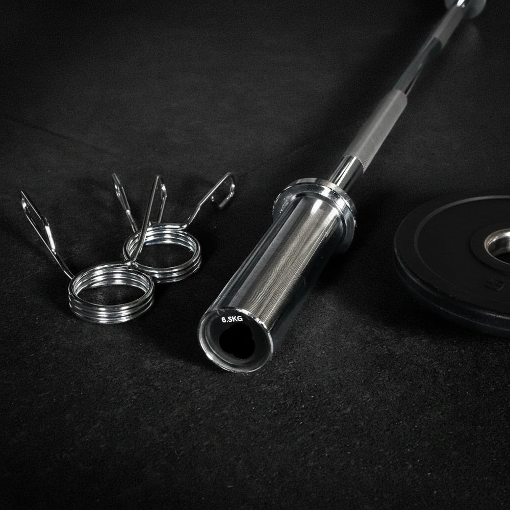 Barbell with weight plates and hooks on a dark surface