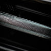 Close-up of a textured dumbbell grip black and gray surface