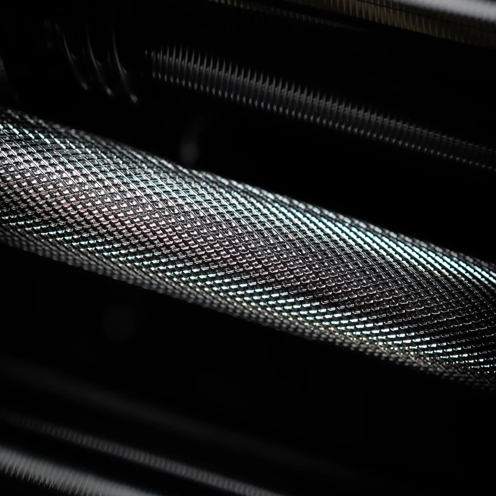 Close-up of a textured dumbbell grip black and gray surface