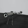 Metallic barbell  on a black surface with a gray background