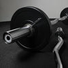 Barbell with weight plates on a dark surface