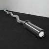 Chrome gym barbell on a black platform with a gray background