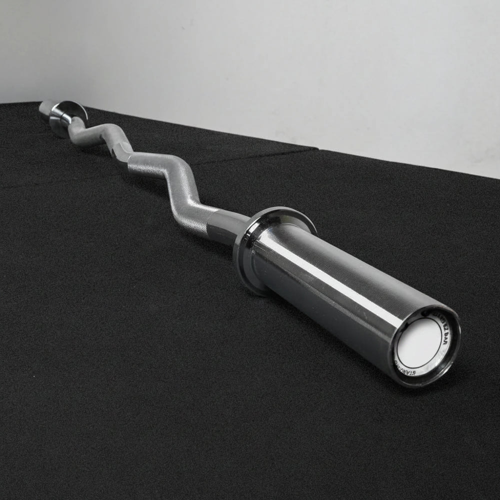Chrome gym barbell on a black platform with a gray background
