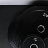 Stack of black weight plates on a dark background