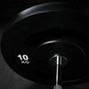 Black weight plate on a dark background