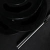 Stack of gym weight plates on a black background