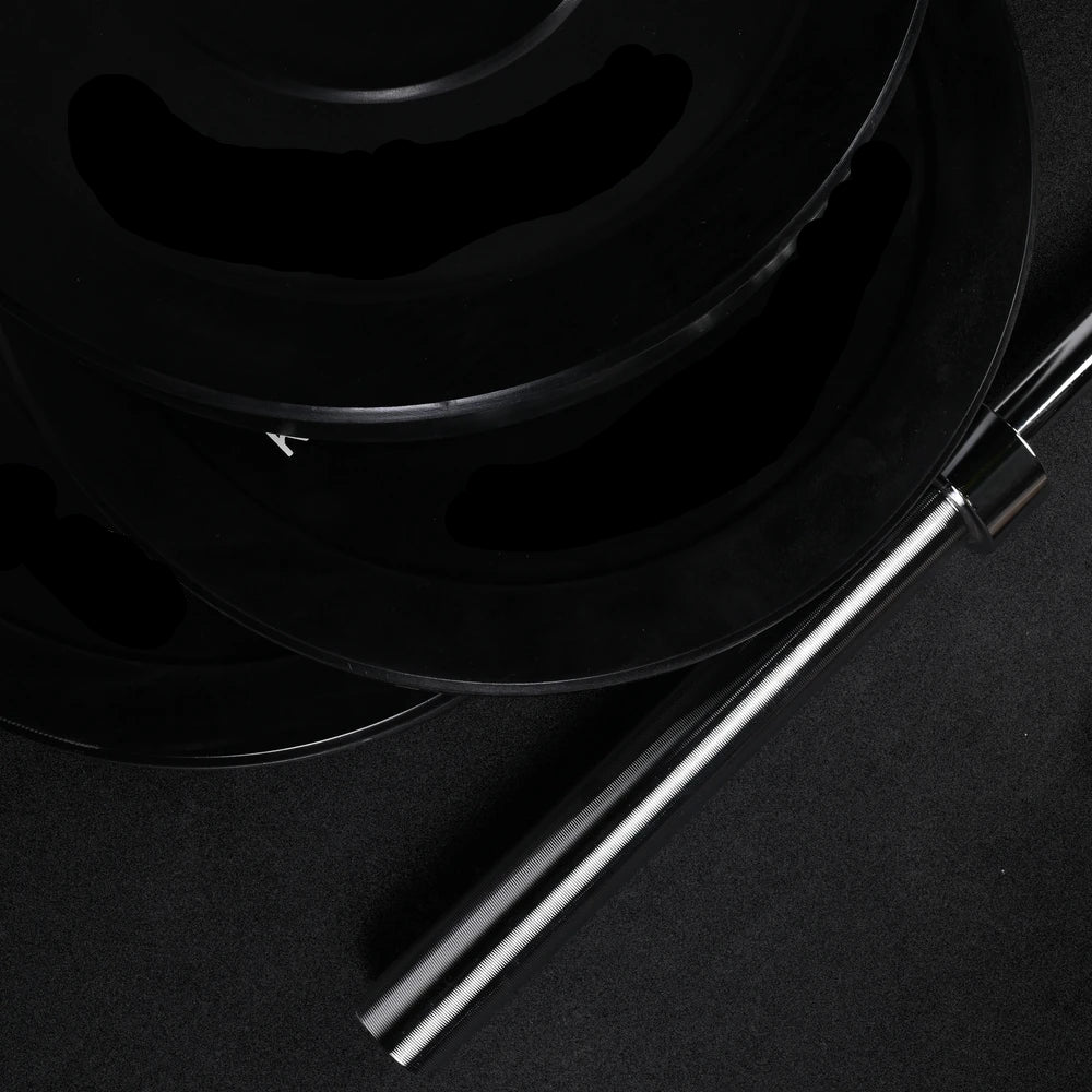 Stack of gym weight plates on a black background