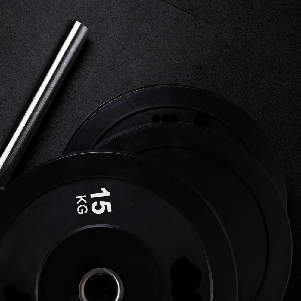Black weight plates on a dark background