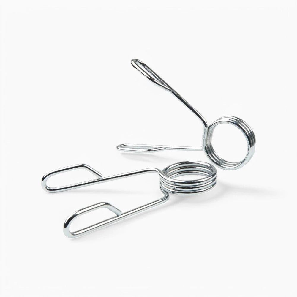 Metallic barbell weight clips on a white background