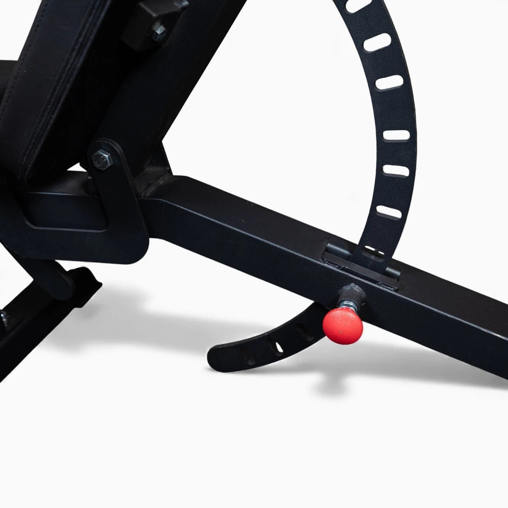 Close-up of a black exercise bike with a red button on a white background