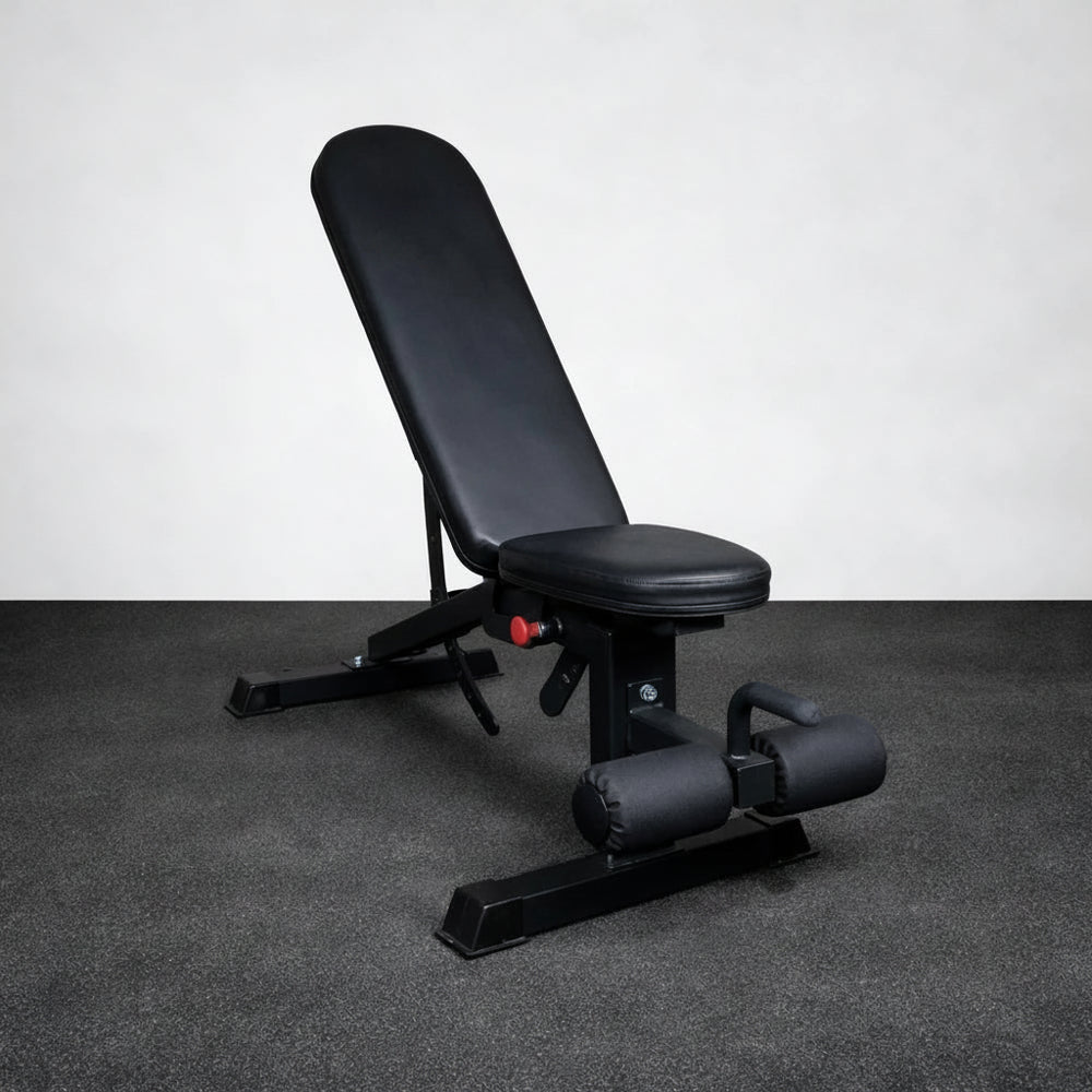 Black adjustable gym bench on a gray floor with a white wall background
