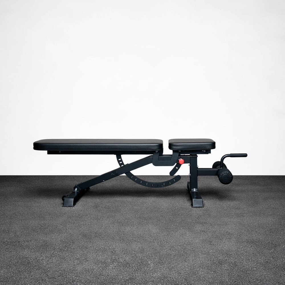 Black adjustable weight bench on a gray floor with a white wall background