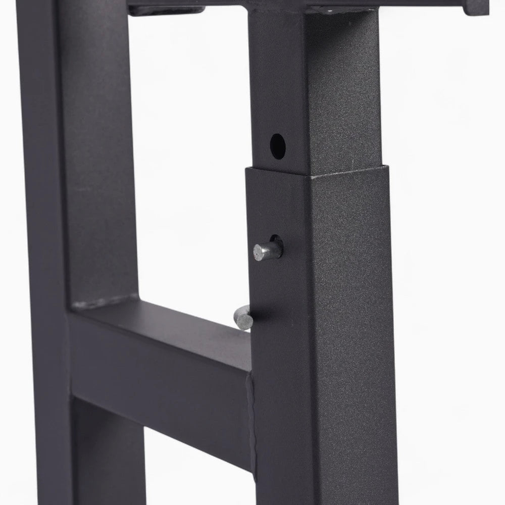 Close-up of a black metal frame with screws on a white background