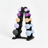 Set of dumbbells on a stand with weight labels on a white background