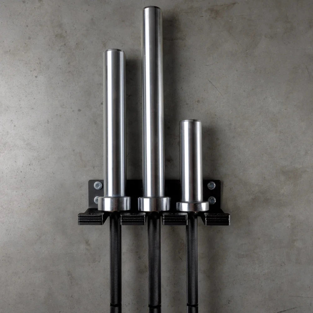 Metal wall-mounted rack with cylindrical hooks on a concrete wall.