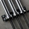 Close-up of metal pipes and brackets on a concrete surface