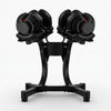 Pair of adjustable dumbbells on a black stand against a white background