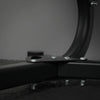 Close-up of a black metal bracket with screws on a dark background