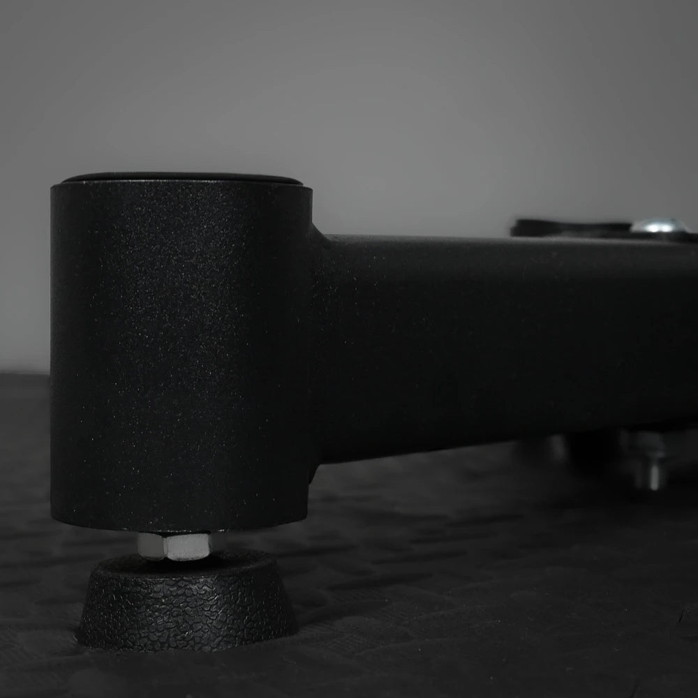 Close-up of a black metal component on a textured surface with a blurred background