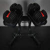 Pair of adjustable dumbbells on stands against a dark background