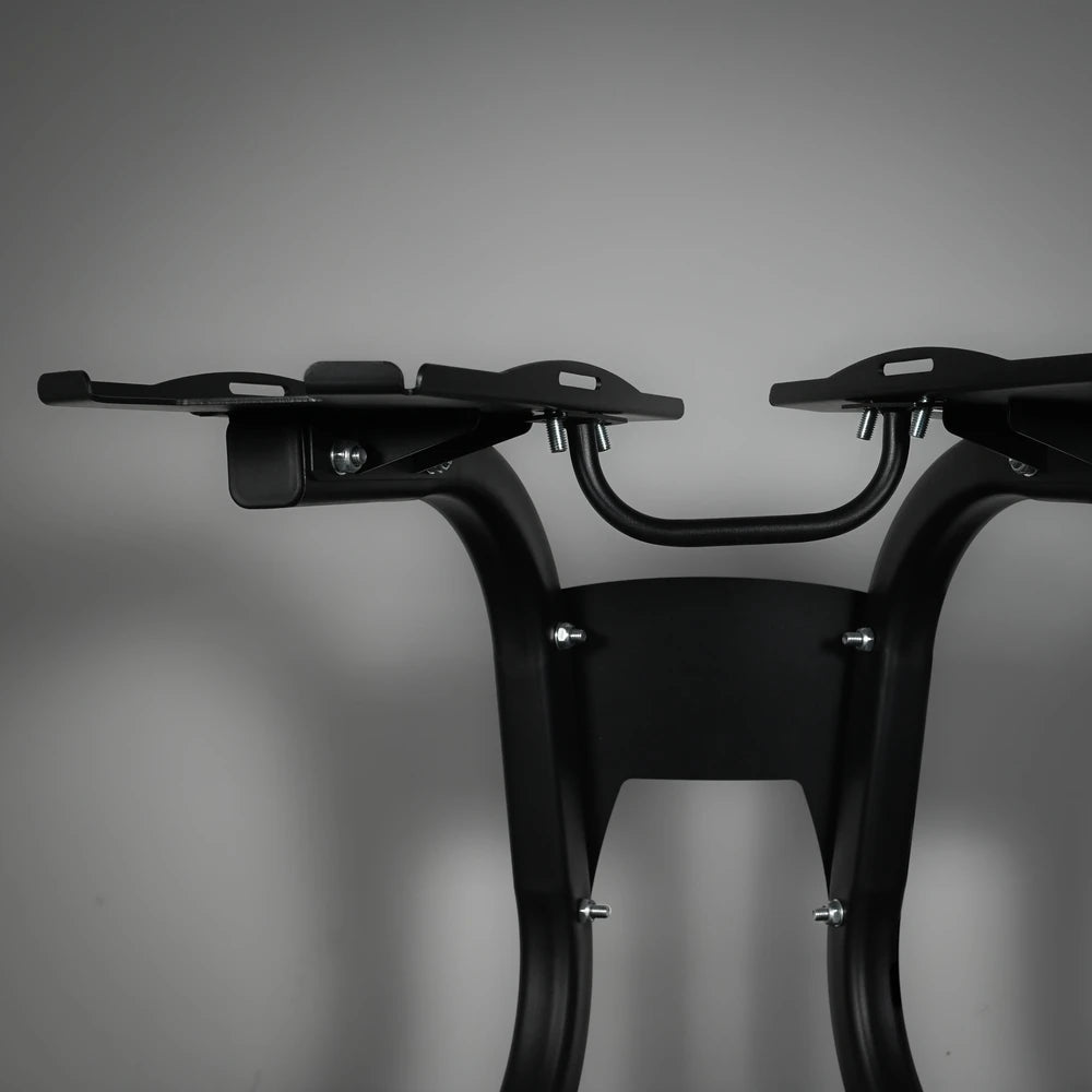 Black metal bike rack on a gray background