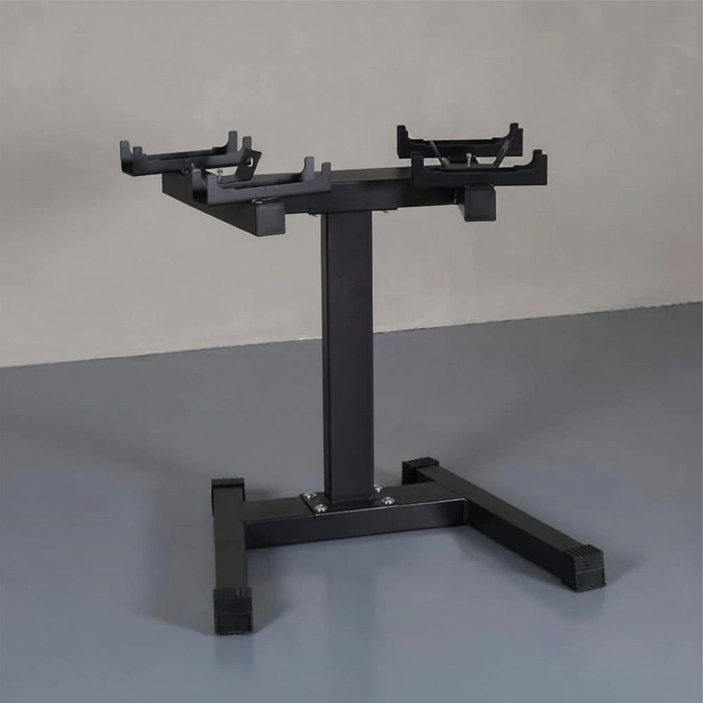Black weight plate stand on a gray floor with a neutral background