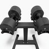 Pair of black dumbbells on a stand on a white background