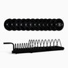 Set of weight plates with a black metal rack on a white background