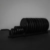 Set of weight plates on a stand against a gray background