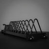 Black metal weight plate rack on a dark background