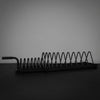 Metal weight rack with springs on a dark surface and gray background