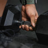 Hand holding a dumbbell with a blurred background