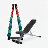 Dumbbell set with colorful weights and a weight bench on a white background