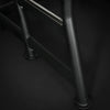 Black metal ladder on a black background
