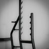 Black metal weight rack against a gray background