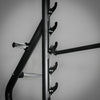 Black metal barbell rack with hooks on a gray background